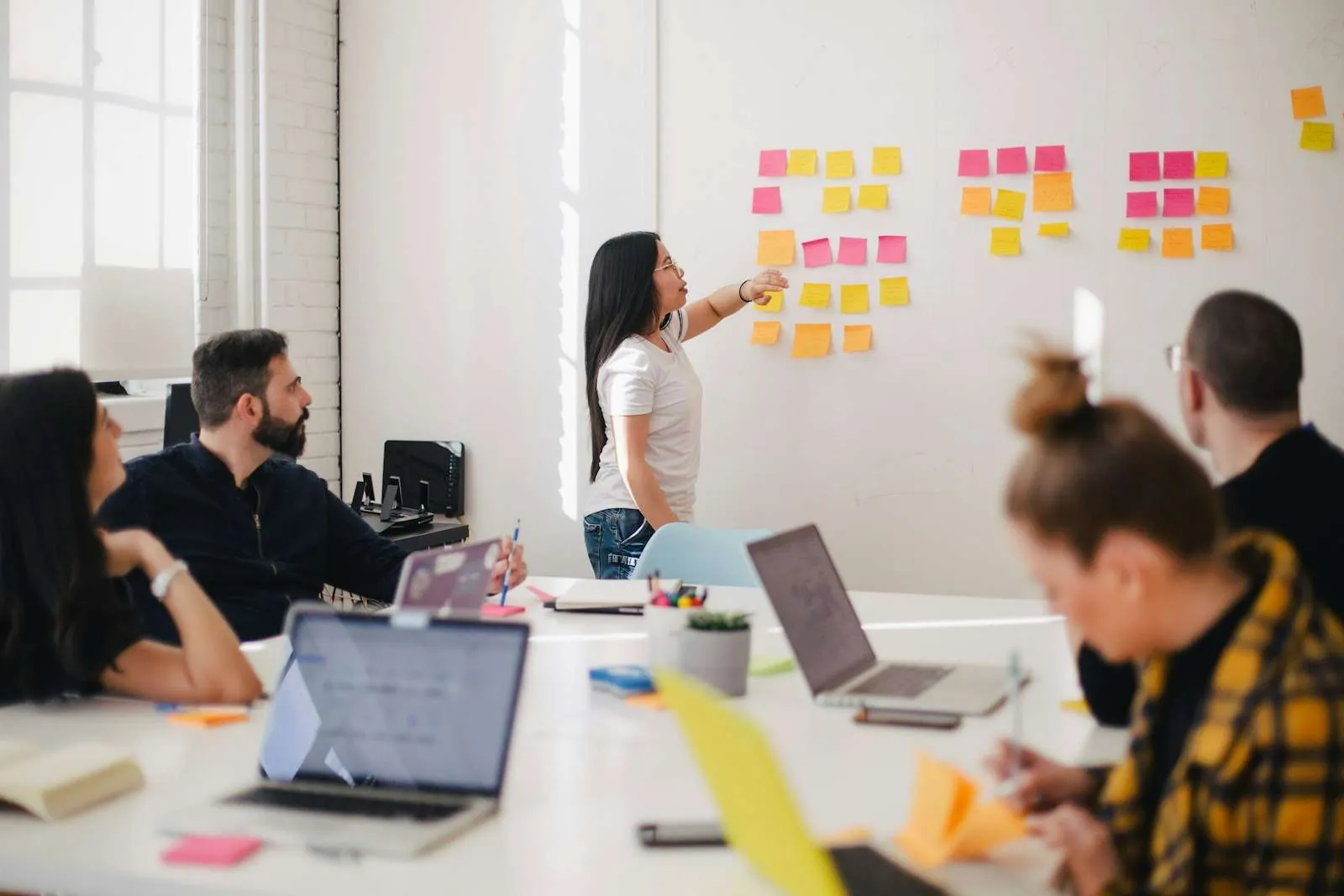 Marketing team reviewing pricing strategy and website structure on a whiteboard